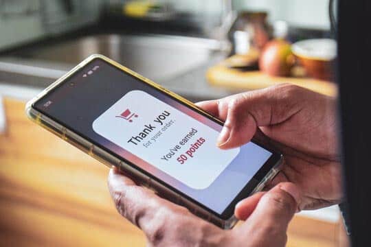 An image of a digital loyalty card on a phone screen with points symbols | ماجرا | Majara